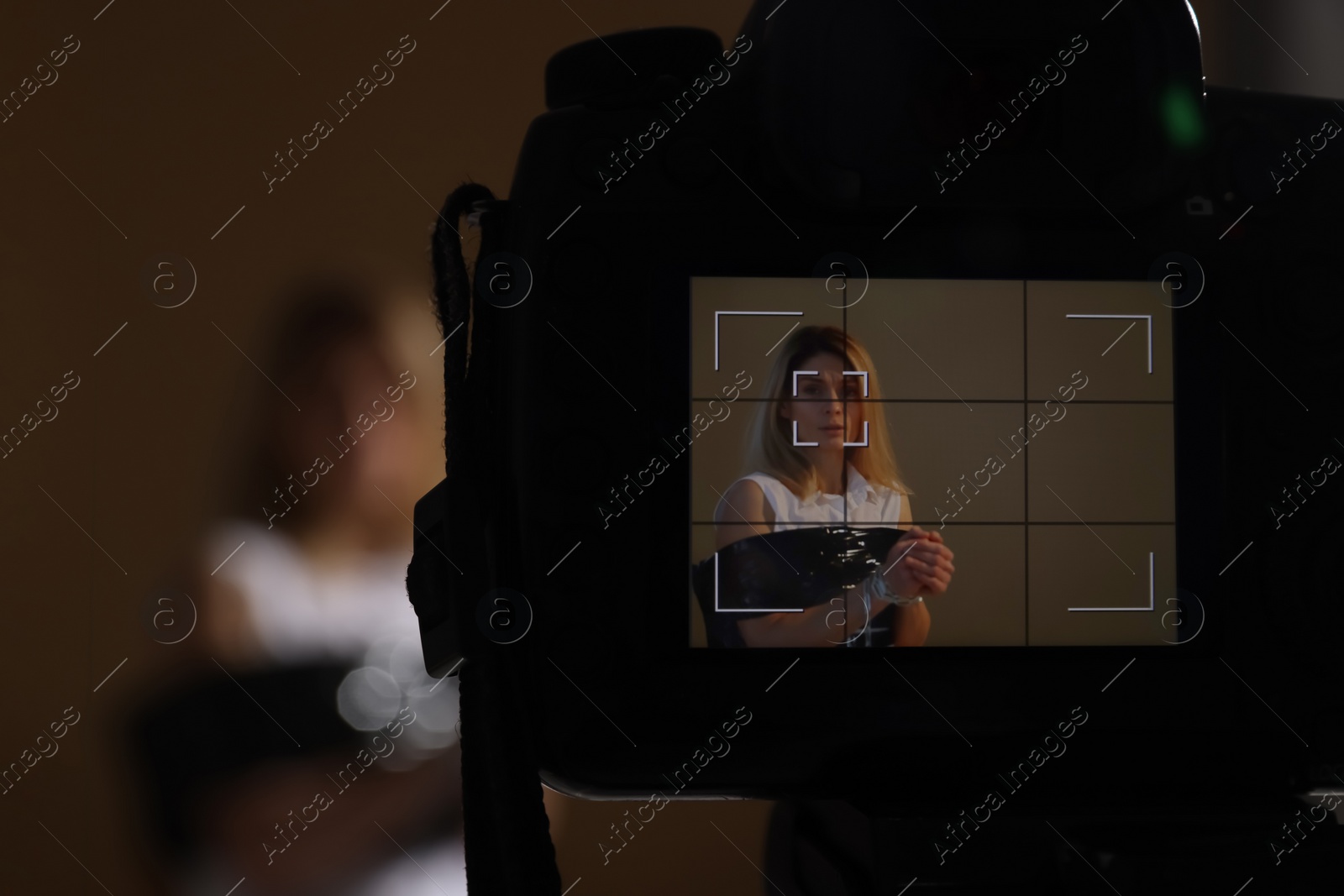 Photo of Woman taped up and taken hostage on dark background, view through camera screen