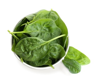 Fresh green healthy baby spinach leaves in ceramic bowl isolated on white, top view