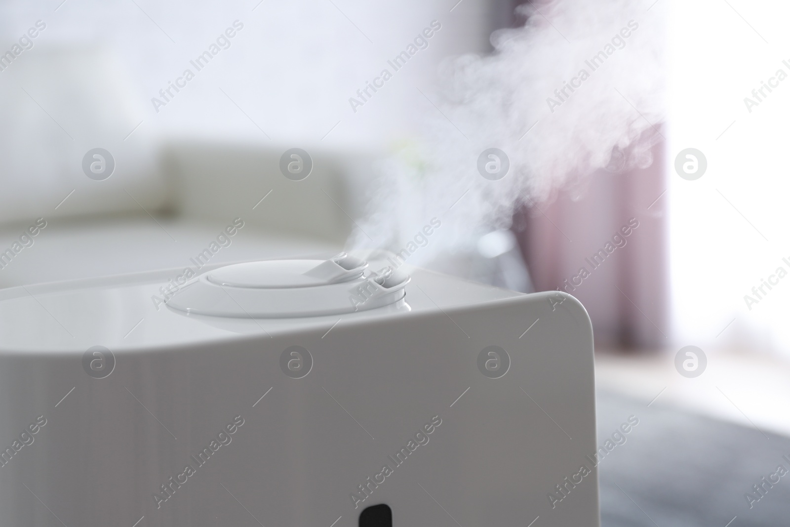 Photo of Modern air humidifier at home, closeup view