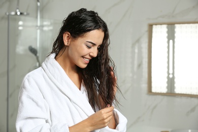Image of Beautiful young woman with wet hair in bathroom. Space for text