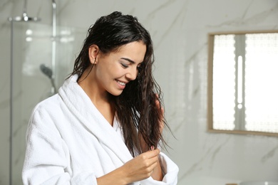 Beautiful young woman with wet hair in bathroom. Space for text