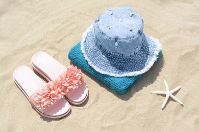 Photo of Stylish beach accessories on sand outdoors, above view