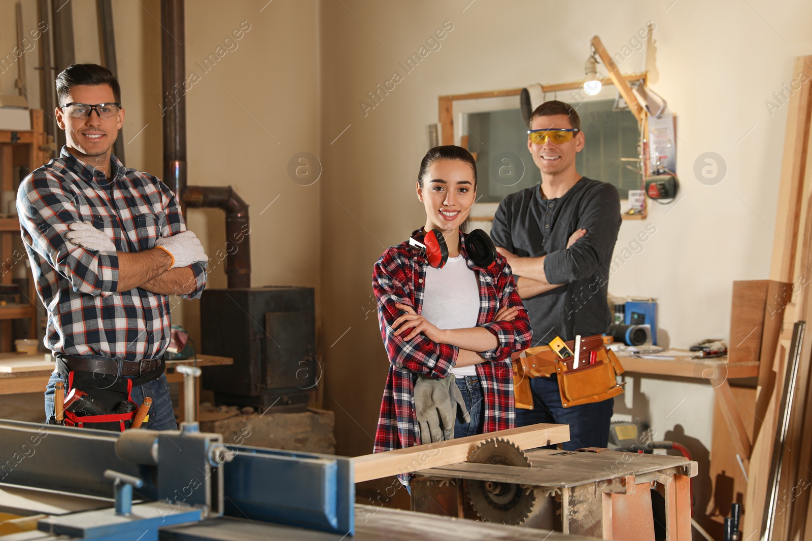 Photo of Team of professional carpenters in modern workshop