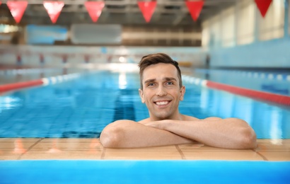 Photo of Young athletic man in swimming pool