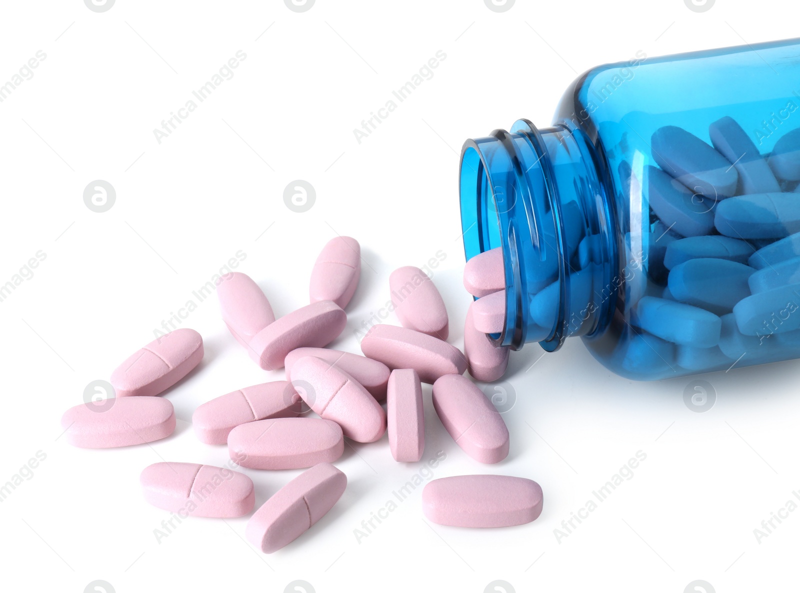 Photo of Scattered vitamin pills and bottle isolated on white