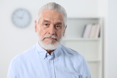 Photo of Portrait of handsome senior man in office. Space for text