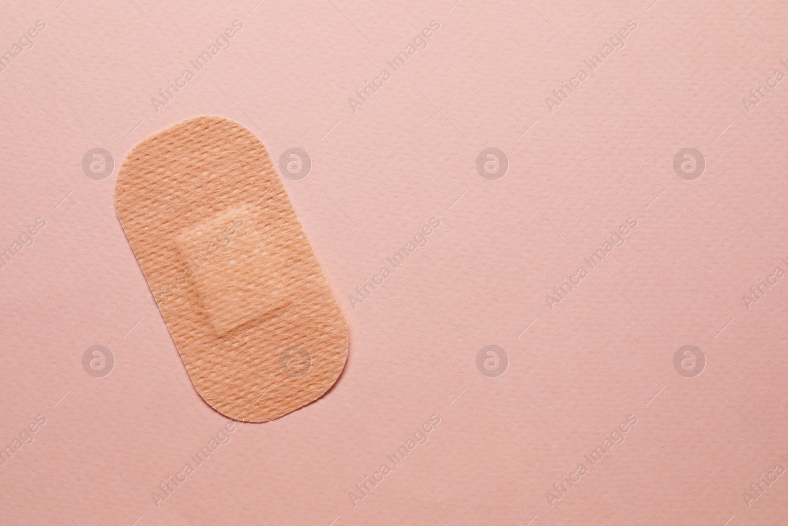 Photo of Contraceptive patch on pink background, top view. Space for text