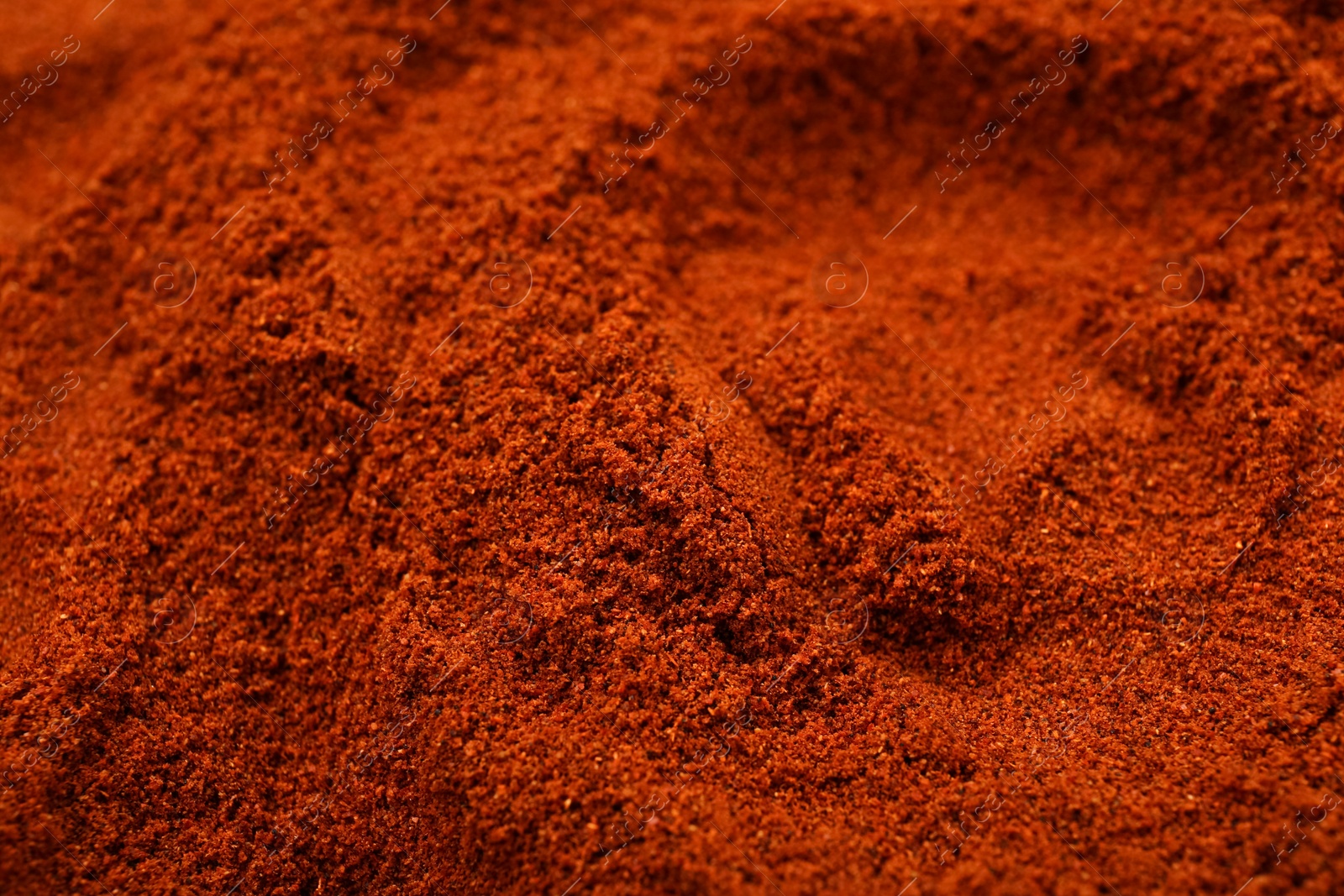 Photo of Aromatic paprika powder as background, closeup view