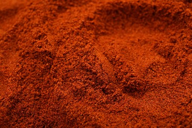 Photo of Aromatic paprika powder as background, closeup view