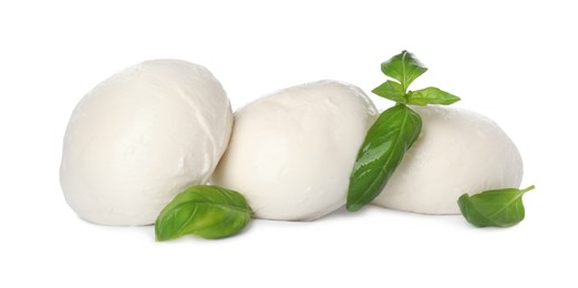 Photo of Delicious mozzarella cheese balls and basil on white background