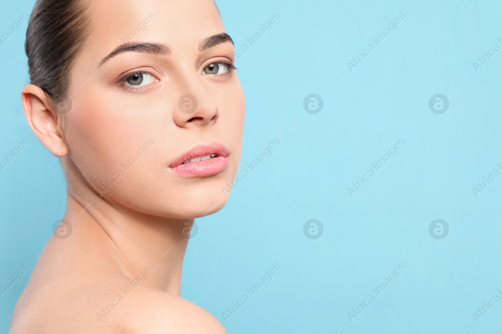 Photo of Portrait of young woman with beautiful face and natural makeup on color background, closeup. Space for text