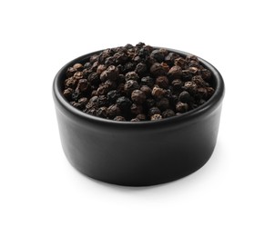 Photo of Aromatic spice. Many black peppercorns in bowl isolated on white