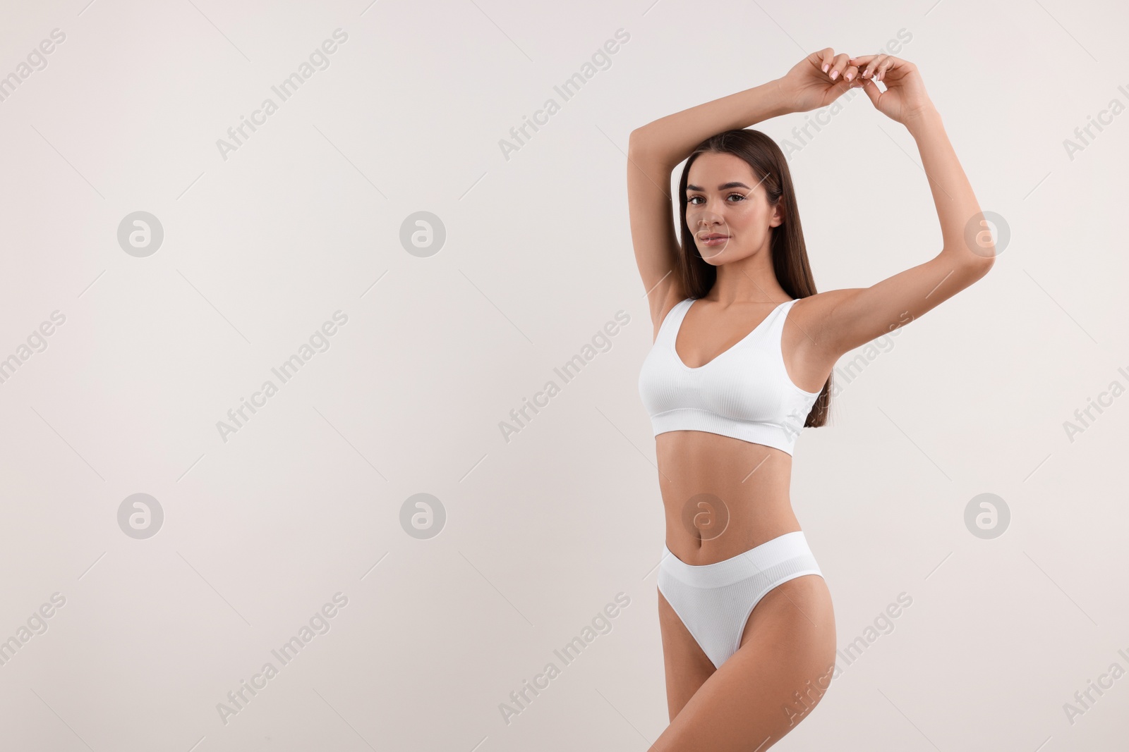 Photo of Young woman in stylish bikini on white background. Space for text