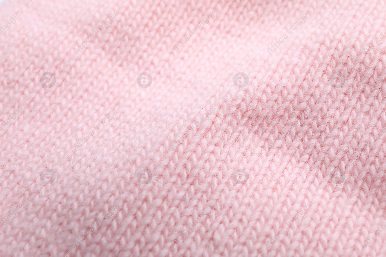 Photo of Pink knitted sweater as background, closeup view