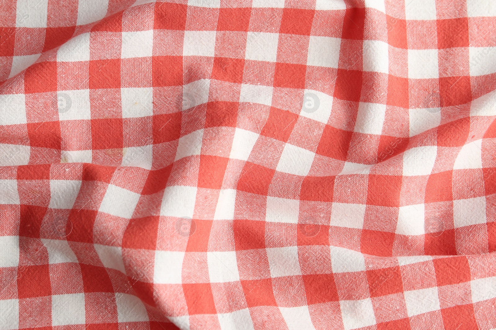 Photo of Texture of red checkered fabric as background, closeup