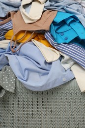 Photo of Plastic laundry basket with clothes, closeup view