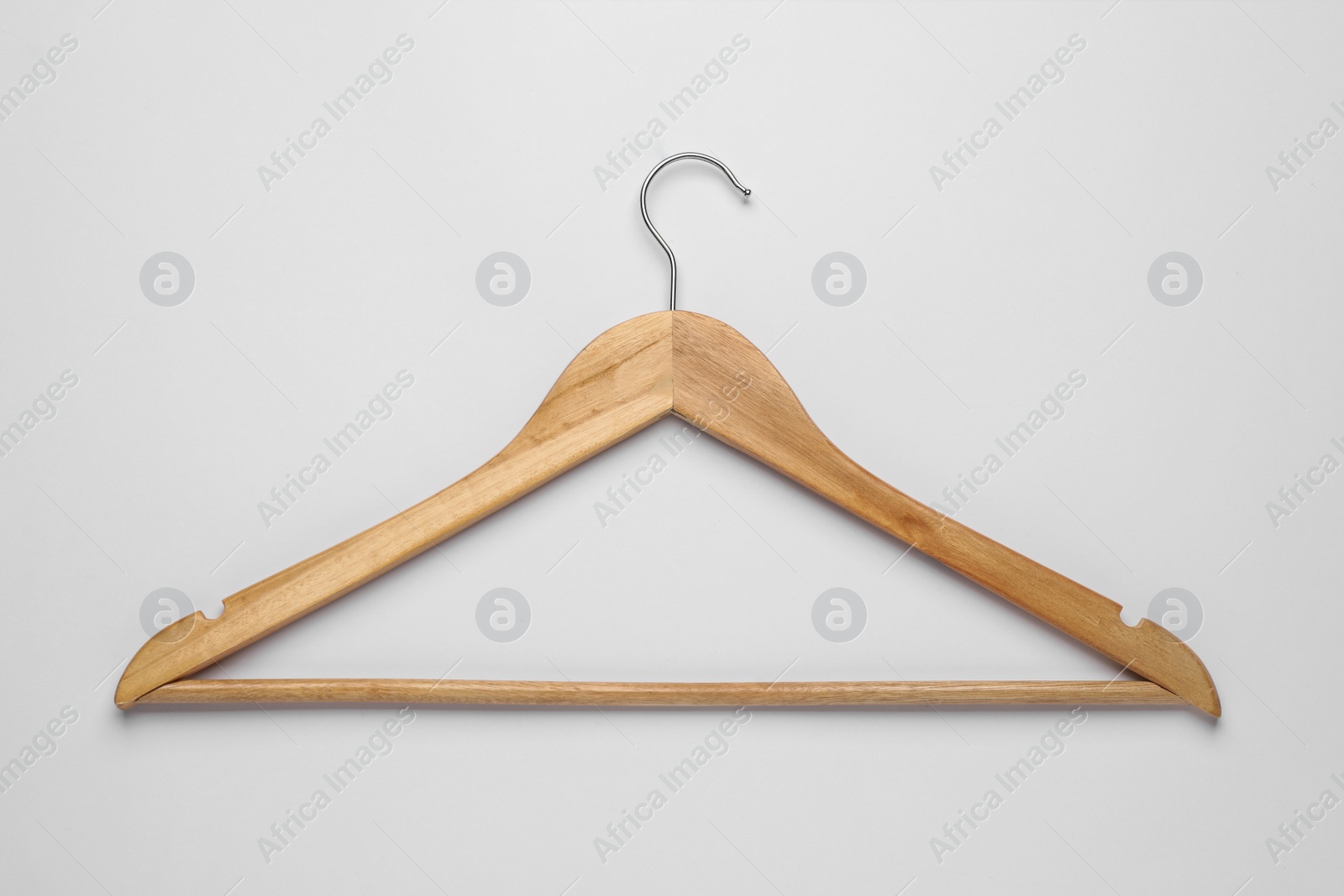 Photo of Empty wooden hanger on light grey background, top view