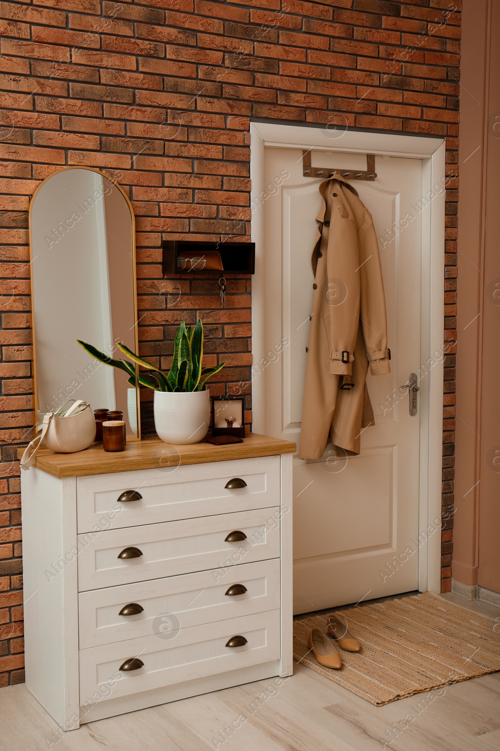 Photo of Stylish hanger for keys on brick wall in hallway