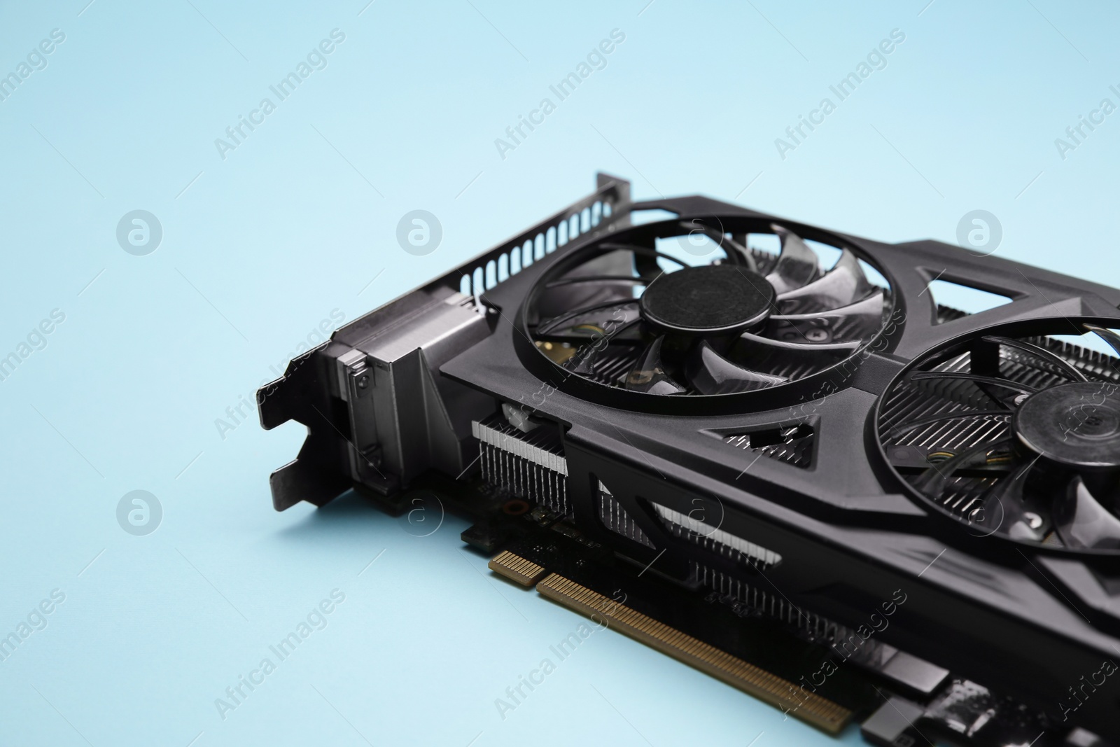 Photo of One graphics card on light blue background, closeup