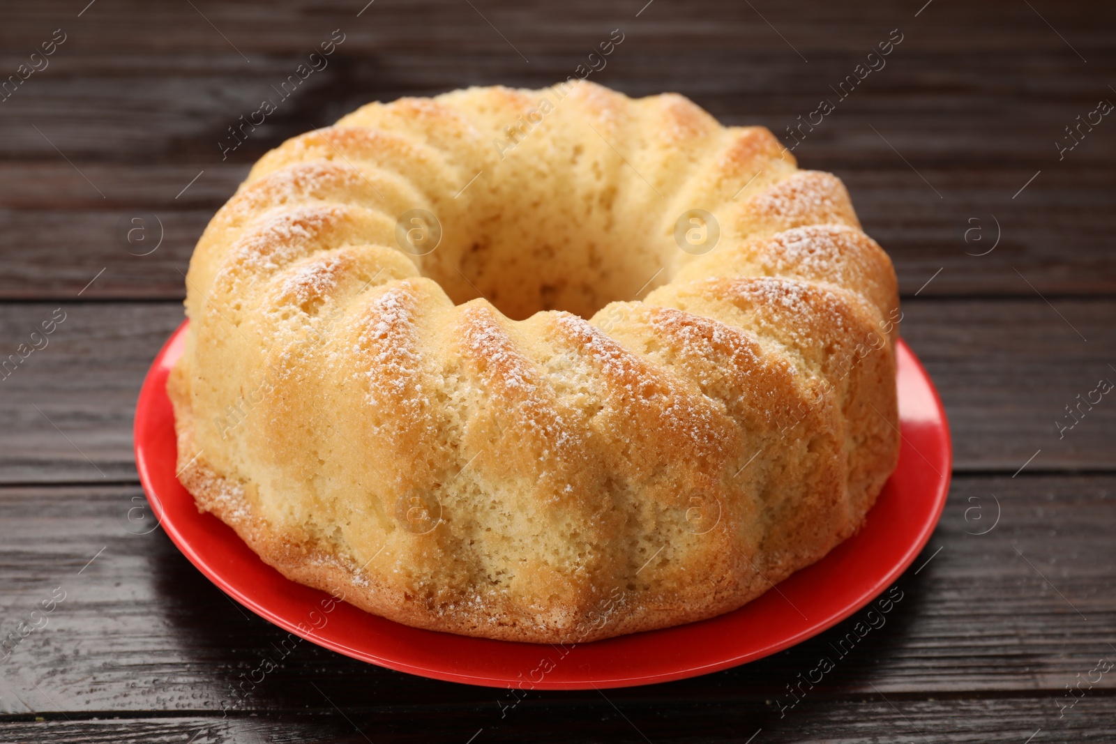 Photo of Delicious freshly baked sponge cake on wooden table, closeup