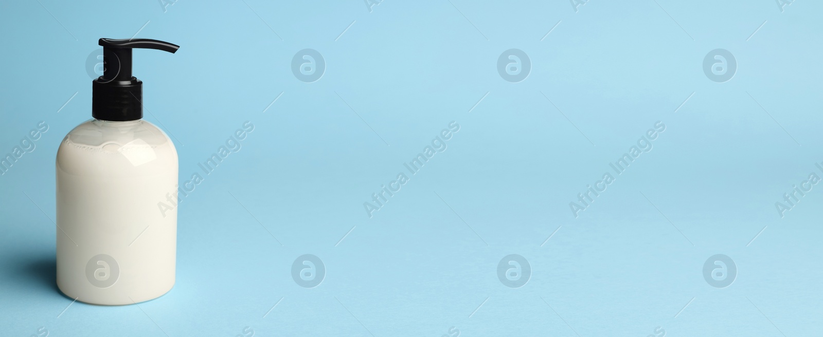 Image of Bottle of liquid soap on light blue background, space for text. Banner design