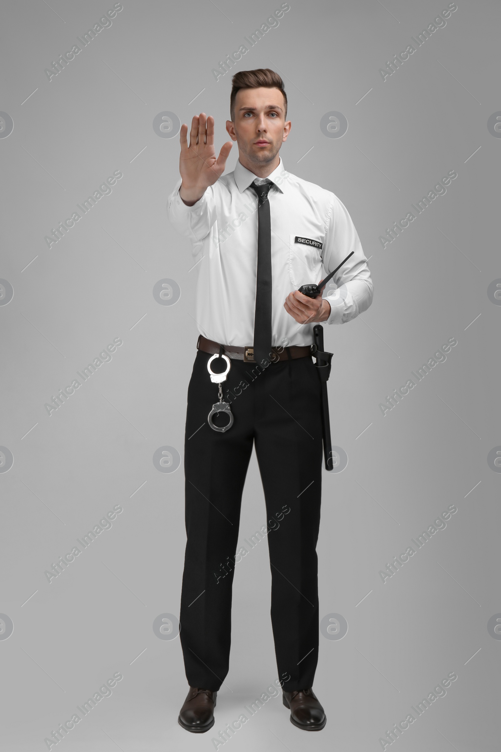 Photo of Male security guard in uniform on color background