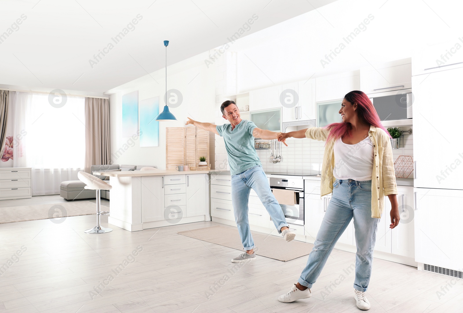 Photo of Beautiful couple dancing in kitchen at home