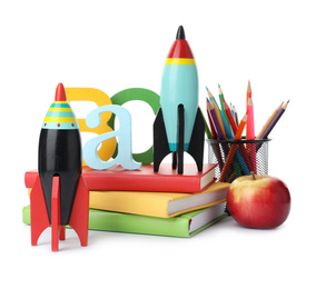 Bright toy rockets and school supplies on white background