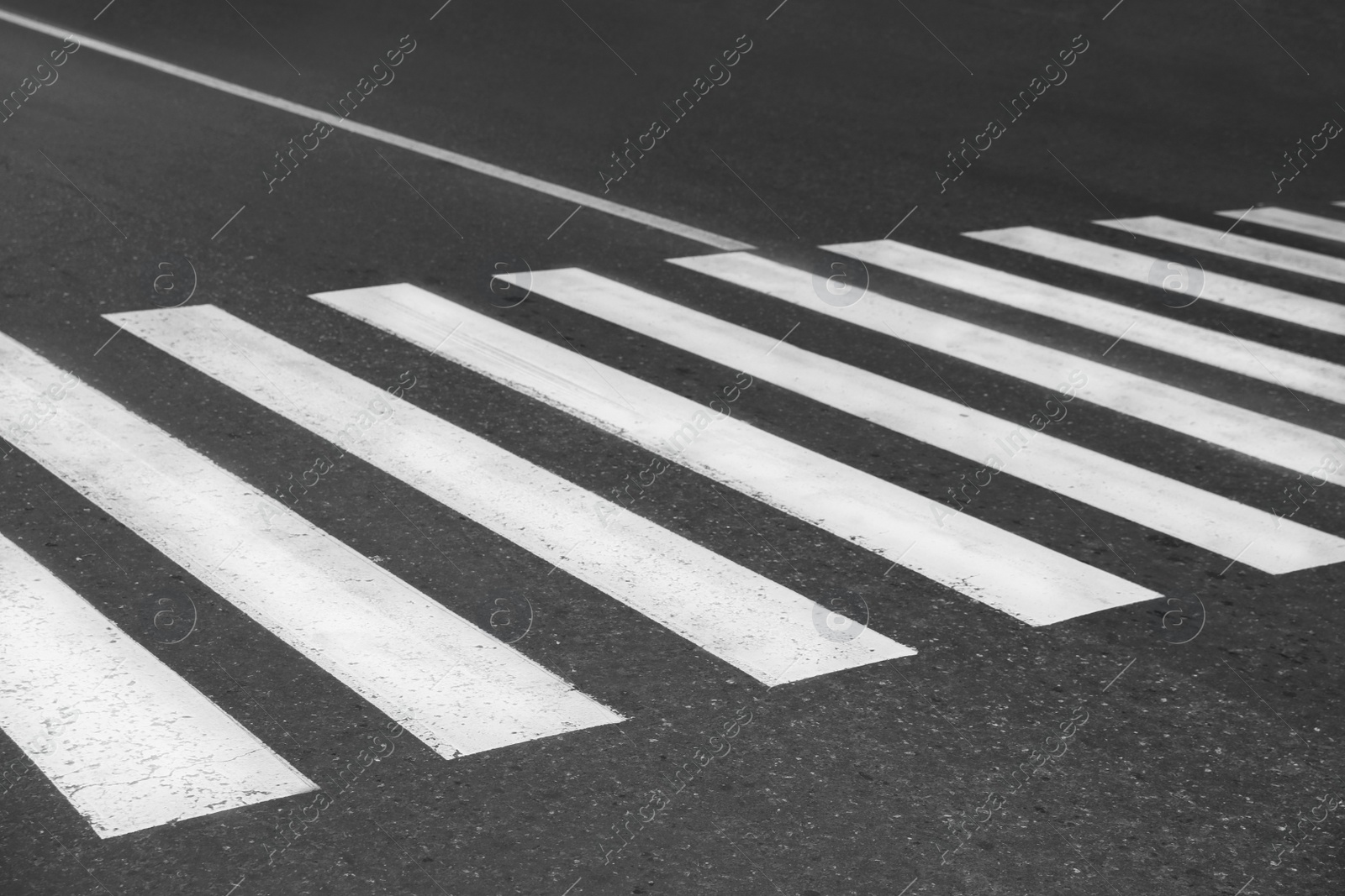 Photo of White pedestrian crossing on empty city street