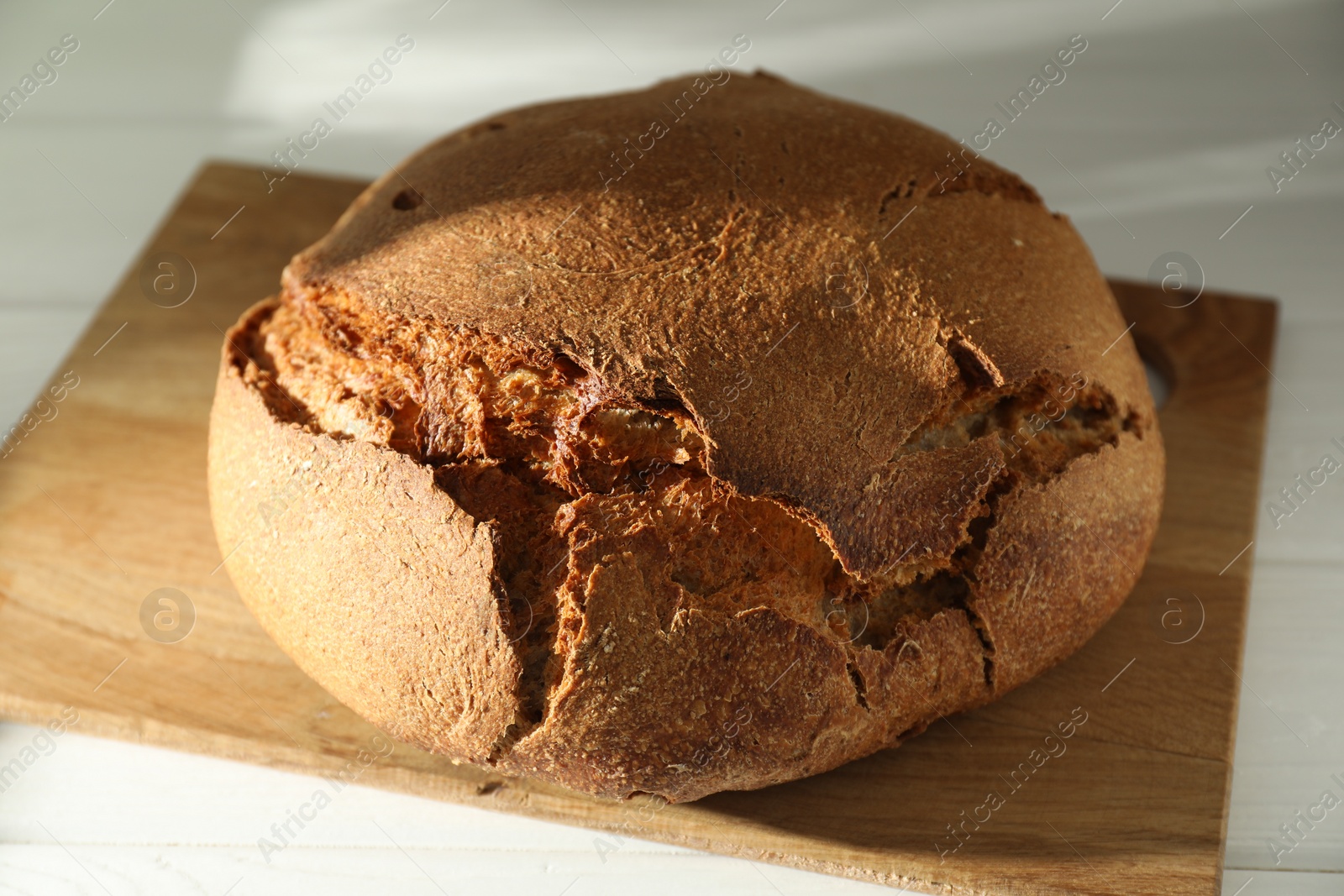 Photo of Freshly baked sourdough bread on white table