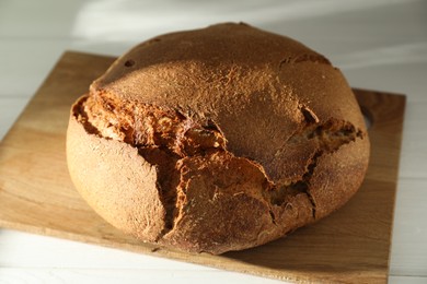 Photo of Freshly baked sourdough bread on white table