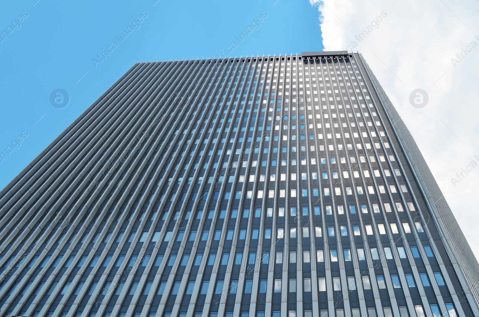 Photo of Beautiful skyscraper on sunny day. Modern architectural design