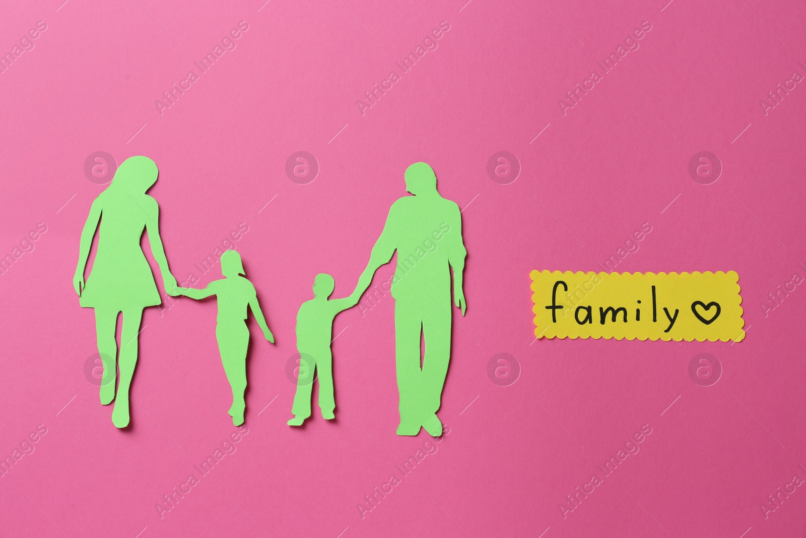 Photo of Card with text Family and paper cutout on pink background, flat lay