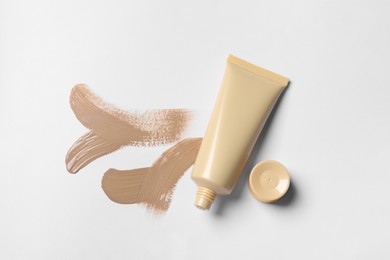 Foundation and swatches on white background, top view