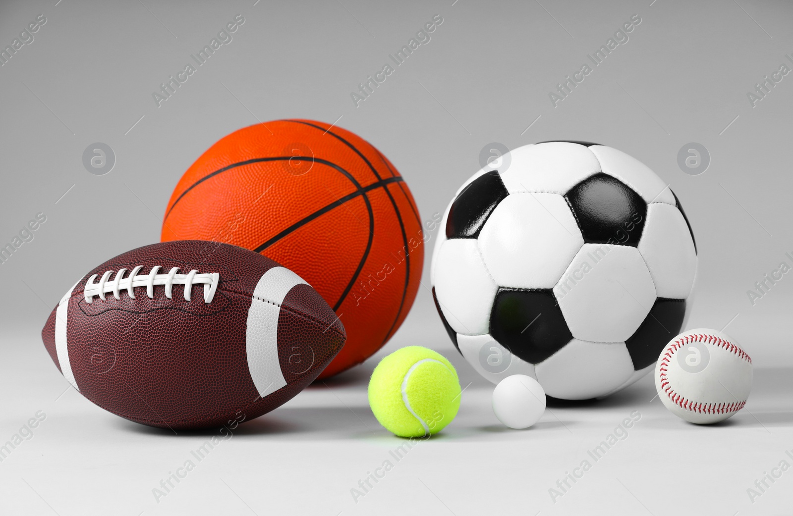 Photo of Many different sports balls on light gray background