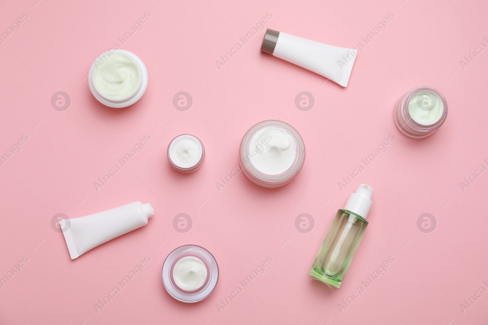 Photo of Flat lay composition with cosmetic products on color background