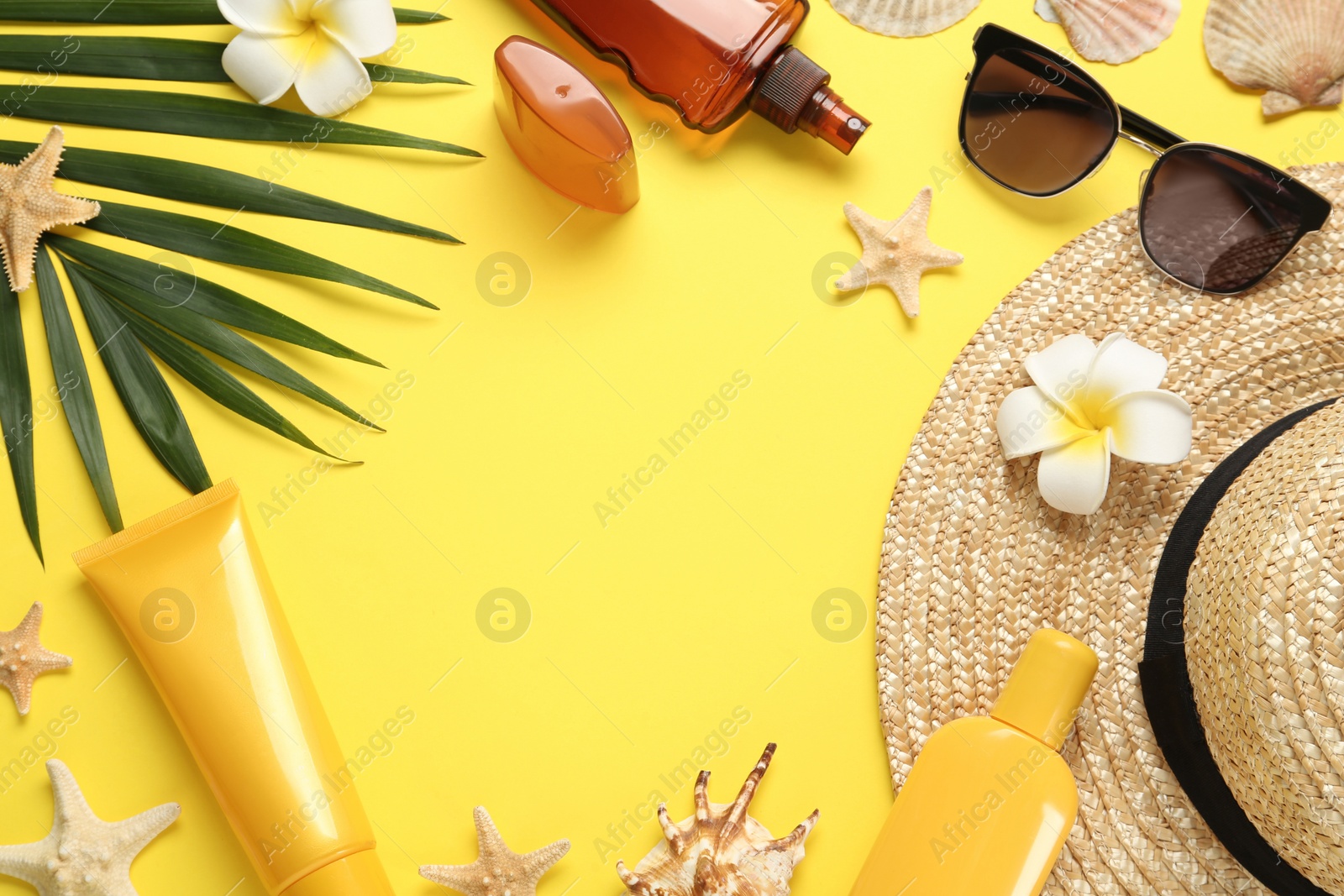 Photo of Sun protection products and beach accessories on yellow background, flat lay. Space for text