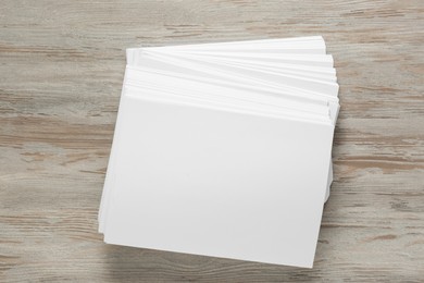 White paper sheets on wooden table, top view