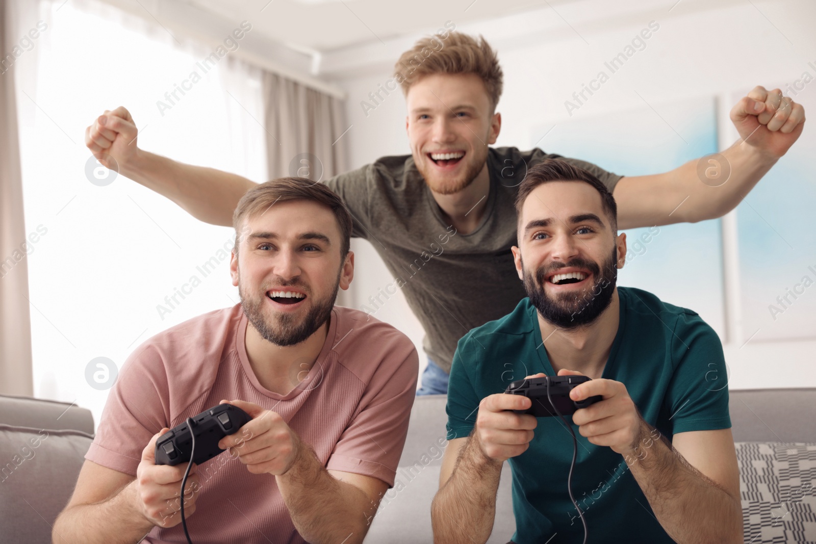 Photo of Emotional friends playing video games at home