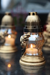 Photo of Grave lights on granite surface at cemetery, closeup