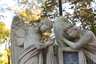 Beautiful statues of angels at cemetery. Religious symbol