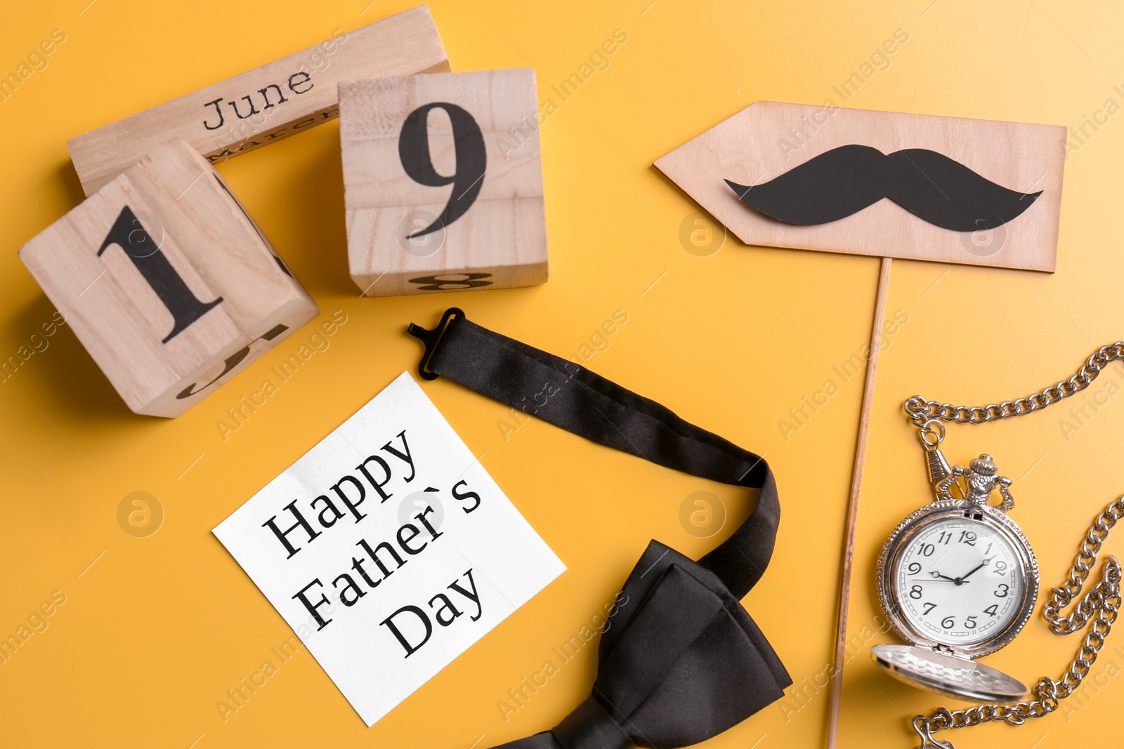 Photo of Composition with calendar, bow tie and clock on color background. Father's day celebration