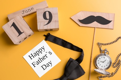 Photo of Composition with calendar, bow tie and clock on color background. Father's day celebration