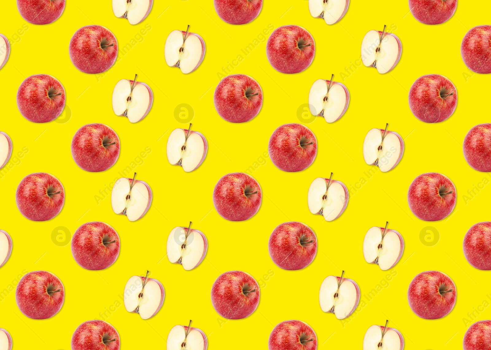 Image of Pattern of whole and halved apples on yellow background