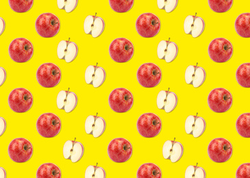 Image of Pattern of whole and halved apples on yellow background