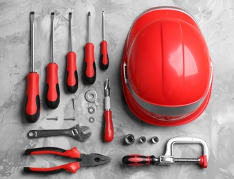 Photo of Flat lay composition with different construction tools on grey background