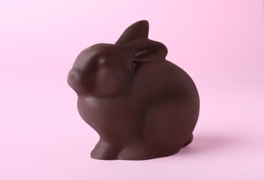 Photo of Chocolate bunny on pink background. Easter celebration