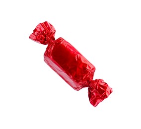 Photo of Tasty candy in red wrapper isolated on white