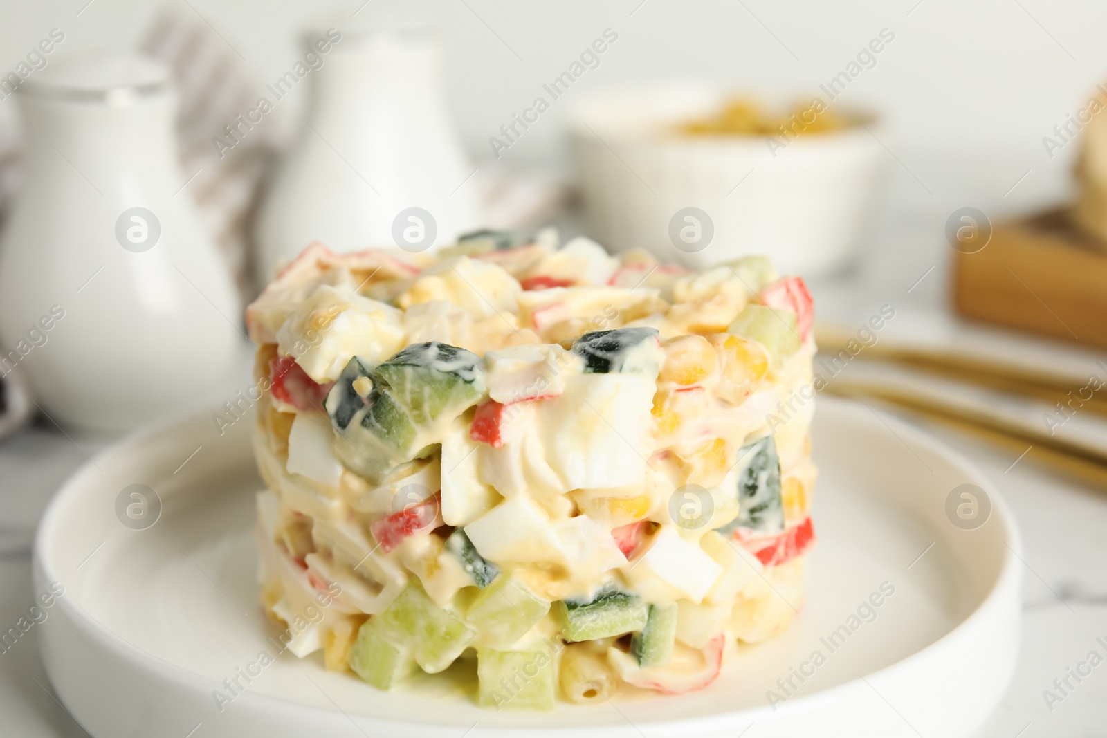 Photo of Delicious salad with fresh crab sticks on plate, closeup