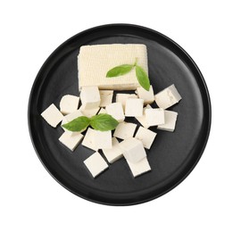 Plate with delicious tofu cheese and basil isolated on white, top view